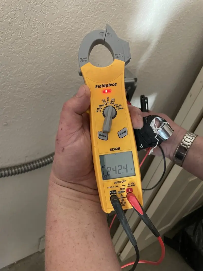 Voltage testing with clamp meter during Electrical Installation Services in De Witt